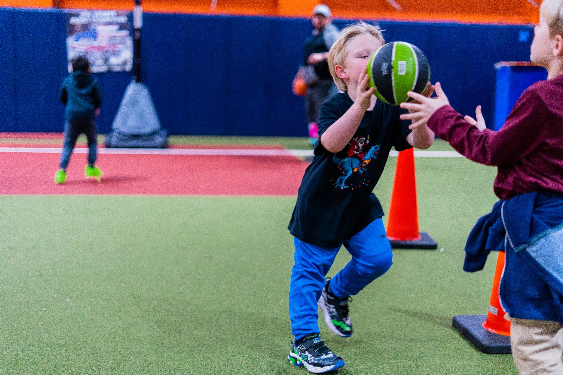 Two campers handling a basketball together during a drill at Junction Place Sportsplex